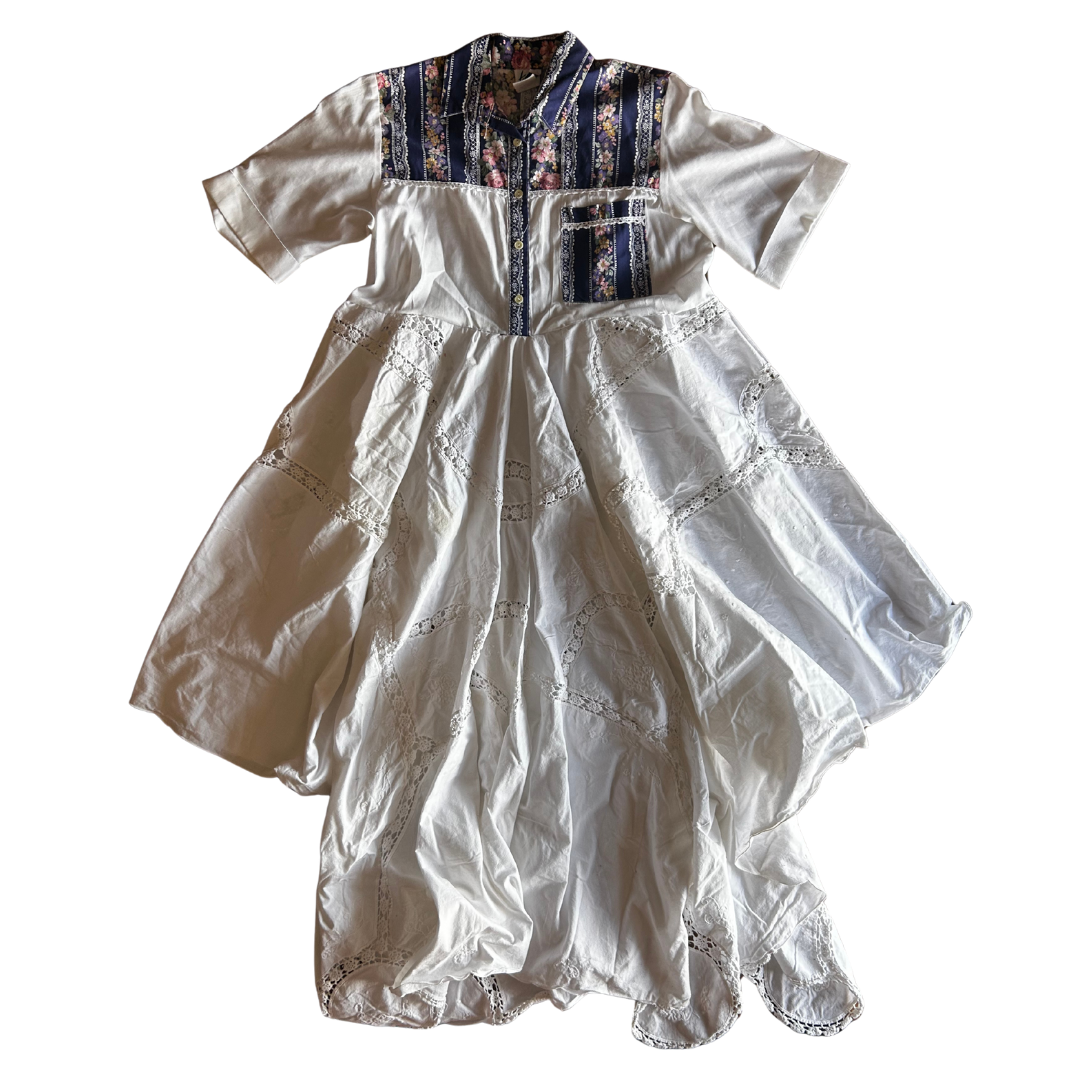 White embroidered dress with colorful patterns on a white background