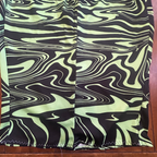 Toxic Swirl Handmade Mini Skirt – One of a Kind Upcycled Statement Piece with green and black swirl pattern.