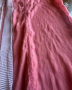 Close-up of the Desert Rose Sheer Kimono Fringe Skirt showcasing dusty pink fabric and lace detailing.