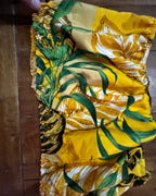 Golden Hour Tropics Two-Piece Set close-up of colorful tropical fabric with vibrant leaves and flowers.