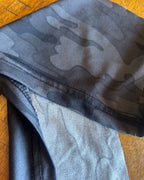 Detail of the Upcycled DRSKN Halter Crop Top – Reworked Activewear, Handmade & One-of-a-Kind in black-on-black camo print.