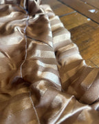 Upcycled Champagne Stripe Lounge Pants fabric detail showing soft satin finish and woven stripes.