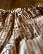 Upcycled Champagne Stripe Lounge Pants showcasing soft champagne-taupe satin finish with woven stripes and elastic waistband.