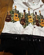 Island Strings Fringe Crop Top featuring a fun guitar print with tropical leaves and dramatic black fringe.
