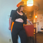 Model wearing the Midnight Mischief Upcycled Two-Piece Set featuring pinstripe and vibrant orange elements.