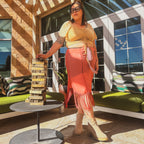 Desert Rose Sheer Kimono Fringe Skirt styled with a trendy top in a vibrant outdoor setting, showcasing unique women's clothing.