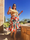 Woman wearing Sunset Tropics Upcycled Ruffle Skirt in a vibrant tropical print, showcasing unique women's clothing.