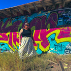 Happy Daze Upcycled Bedsheet Skirt worn against vibrant graffiti backdrop, showcasing unique handmade women's clothing.