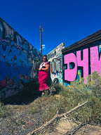 Hot Mess Express Ruffle Skirt worn against colorful graffiti background, showcasing funky women's clothing style.