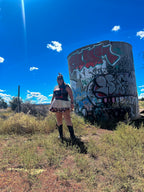 Just Chillin’ Killin’ Upcycled T-Shirt Dress worn outdoors with graffiti backdrop, showcasing funky and unique women's clothing.