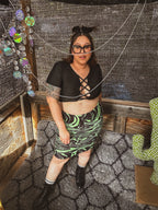 Toxic Swirl Handmade Mini Skirt – One of a Kind Upcycled Statement Piece worn by model in a unique setting.