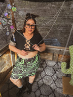 Toxic Swirl Handmade Mini Skirt – One of a Kind Upcycled Statement Piece worn with a black top in a vibrant styled setting.