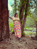 Woman in nature wearing Cosmic Scarf Remix Skirt – One of a Kind Upcycled Statement Piece with vibrant colors and patterns.