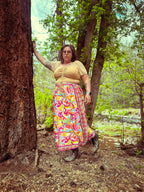 Woman wearing Cosmic Scarf Remix Skirt – One of a Kind Upcycled Statement Piece in vibrant colors outdoors.