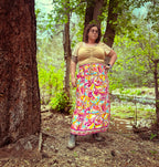 Cosmic Scarf Remix Skirt – One of a Kind Upcycled Statement Piece worn outdoors among trees with colorful patterns and lively colors.