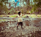 Model in the Midnight Lace Remix Maxi Dress – One of a Kind Upcycled Statement Piece near a stream.