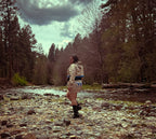Ultra Remix Hoodie Set – One of a Kind Upcycled Statement Set worn by a woman by a river in a forest setting.