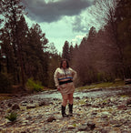 Model showcasing the Ultra Remix Hoodie Set – One of a Kind Upcycled Statement Set by a river in a forest.