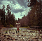 Woman modeling the Ultra Remix Hoodie Set – One of a Kind Upcycled Statement Set in a natural setting with trees and water.