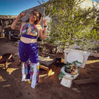 Model showcasing the Electric Pulse Bell Bottom Set, a unique handmade outfit, vibrant colors and confident pose.