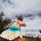 Beavis & Butt-Head Smiley Tank Dress worn by a woman in a whimsical outdoor setting.