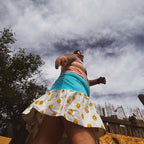 Beavis & Butt-Head Smiley Tank Dress worn outdoors with a turquoise panel and smiley-face ruffle, showcasing unique women's clothing.
