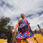 Woman in Bloom Riot Maxi Dress, showcasing funky women's clothing with vibrant floral print, perfect for unique fashion.